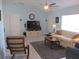 Comfortable living room features light walls, neutral tile flooring, ceiling fan, and cozy furnishings at 13779 Sw 115Th Cir, Dunnellon, FL 34432