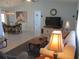 Open-concept living room features neutral walls, tile flooring, ceiling fan and a comfortable seating area at 13779 Sw 115Th Cir, Dunnellon, FL 34432