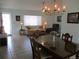 The living room has tile floors, a ceiling fan, chandelier, and blends seamlessly into the dining area at 13779 Sw 115Th Cir, Dunnellon, FL 34432