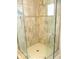 Modern shower showcasing glass doors, neutral tile, grab bar and a built-in shower head at 13779 Sw 115Th Cir, Dunnellon, FL 34432