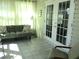 Relaxing sunroom with tiled floors, comfortable furniture, and views of the outdoors at 13779 Sw 115Th Cir, Dunnellon, FL 34432