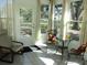Cozy sunroom filled with natural light with large windows and a view of mature trees at 13779 Sw 115Th Cir, Dunnellon, FL 34432