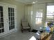 Bright sunroom with double french doors, neutral decor, tiled floor, and views of the outdoor space at 13779 Sw 115Th Cir, Dunnellon, FL 34432