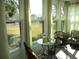 Serene sunroom with comfortable seating, filled with natural light and backyard views at 13779 Sw 115Th Cir, Dunnellon, FL 34432
