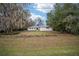 Exterior of a one-story home with white paint, brown roof, and green grass in front at 1610 Se 22Nd Ave, Ocala, FL 34471