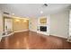 Expansive living room with a traditional fireplace, hardwood floors, natural light, and decorative wall sconces at 1610 Se 22Nd Ave, Ocala, FL 34471