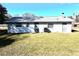 Rear view of the home shows access doors and tidy backyard at 1904 Ne 50Th St, Ocala, FL 34479
