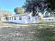 View of backyard and side of home with chain link fence at 1904 Ne 50Th St, Ocala, FL 34479