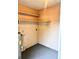 Unfinished basement area with painted walls, open shelving, and visible water heater at 1904 Ne 50Th St, Ocala, FL 34479