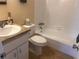 Bathroom offers a tub with tile surround, a modern sink and vanity, and neutral decor at 1904 Ne 50Th St, Ocala, FL 34479