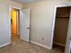 Bedroom features an open closet and adjacent doors and tile flooring at 1904 Ne 50Th St, Ocala, FL 34479