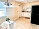 Kitchen and dining area featuring neutral paint, white cabinets and tile flooring at 1904 Ne 50Th St, Ocala, FL 34479