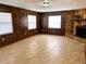 Living room with wood panel walls, tile floors and stone fireplace at 1904 Ne 50Th St, Ocala, FL 34479