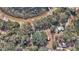 An aerial perspective captures the expansive property, complete with a main house, outbuildings, and a serene lake at 19390 Se 95Th Pl, Ocklawaha, FL 32179