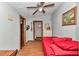 Comfortable bedroom with ceiling fan, bright colors, and wood accents at 19390 Se 95Th Pl, Ocklawaha, FL 32179