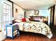 Comfortable bedroom with a decorative fireplace, accent furniture, and natural light at 19390 Se 95Th Pl, Ocklawaha, FL 32179