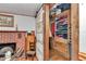 Walk-in closet features an open barn-style door with built-in shelves and drawers at 19390 Se 95Th Pl, Ocklawaha, FL 32179