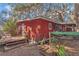 Charming red house with a cozy deck and garden area at 19390 Se 95Th Pl, Ocklawaha, FL 32179