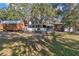Charming home exterior with multiple outbuildings nestled among mature trees providing ample shade at 19390 Se 95Th Pl, Ocklawaha, FL 32179