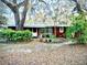 Charming single-story home featuring lush landscaping and mature trees draped with Spanish moss at 19390 Se 95Th Pl, Ocklawaha, FL 32179