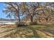 Lakeside property featuring mature trees, serene water views, and a tranquil atmosphere at 19390 Se 95Th Pl, Ocklawaha, FL 32179