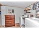 Laundry room includes washer, dryer, shelving and drawers for storage at 19390 Se 95Th Pl, Ocklawaha, FL 32179