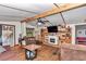 Living room featuring wood floors, fireplace, and comfortable seating at 19390 Se 95Th Pl, Ocklawaha, FL 32179