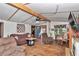 Cozy living room with wood floors, exposed beams, and comfortable seating at 19390 Se 95Th Pl, Ocklawaha, FL 32179