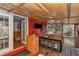 Cozy covered outdoor bar area with sink, TV, seating, and wood accents; perfect for entertaining at 19390 Se 95Th Pl, Ocklawaha, FL 32179
