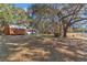 Spacious yard with mature trees and lake access create an inviting outdoor setting at 19390 Se 95Th Pl, Ocklawaha, FL 32179