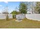 View of backyard utility shed, water tank, and white privacy fence at 2 Hemlock Terrace Trl, Ocala, FL 34472