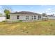 Backyard with a patio, white picket fence, and a spacious grassy area at 2 Hemlock Terrace Trl, Ocala, FL 34472