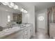 Bright bathroom featuring double sinks, granite countertops, and tiled floors at 2 Hemlock Terrace Trl, Ocala, FL 34472