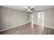 Spacious main bedroom with a ceiling fan, wood flooring, and ensuite bathroom at 2 Hemlock Terrace Trl, Ocala, FL 34472