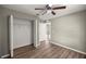 Bedroom with closet, ceiling fan, wood-look floors, and neutral paint at 2 Hemlock Terrace Trl, Ocala, FL 34472
