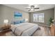 Main bedroom with a ceiling fan, picture window, area rug, and stylish decor at 2 Hemlock Terrace Trl, Ocala, FL 34472