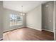 Open dining room with light wood floors, large window providing natural light, and a modern light fixture at 2 Hemlock Terrace Trl, Ocala, FL 34472