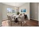 Well-lit dining room features a modern chandelier, area rug, and large window providing natural light at 2 Hemlock Terrace Trl, Ocala, FL 34472
