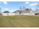 Well-maintained single-story home with a lush front lawn, privacy fence, and attached garage at 2 Hemlock Terrace Trl, Ocala, FL 34472