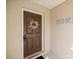 Close-up of a welcoming front door adorned with a decorative wreath and modern digital lock at 2 Hemlock Terrace Trl, Ocala, FL 34472