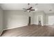 Spacious living room with hardwood floors, ceiling fan, and ample natural light, perfect for relaxation at 2 Hemlock Terrace Trl, Ocala, FL 34472