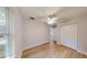 Cozy bedroom showcasing light wood floors, a ceiling fan, a window and a spacious closet at 24237 Sw South Lakes Ct, Dunnellon, FL 34431