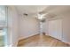 Bedroom with wood floors, a ceiling fan, a closet, and an exterior view at 24237 Sw South Lakes Ct, Dunnellon, FL 34431