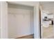 Open closet with white doors and wire shelving, seamlessly connecting to the modern kitchen at 24237 Sw South Lakes Ct, Dunnellon, FL 34431