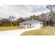 Charming single-story home featuring a paved driveway, attached garage, and well-maintained lawn at 24237 Sw South Lakes Ct, Dunnellon, FL 34431