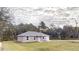 Charming single-story home featuring a paved driveway, attached garage, and well-maintained lawn at 24237 Sw South Lakes Ct, Dunnellon, FL 34431