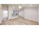 Open-concept living space boasting light wood floors, recessed lighting, white walls, and a view of the kitchen at 24237 Sw South Lakes Ct, Dunnellon, FL 34431