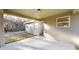Covered patio featuring a concrete floor and a view of the wooded backyard at 24237 Sw South Lakes Ct, Dunnellon, FL 34431