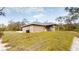 Backyard featuring a covered patio, lush greenery, and privacy at 24264 Sw South Hills Ct, Dunnellon, FL 34431