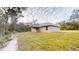 Spacious backyard featuring a covered patio, lush greenery, and privacy at 24264 Sw South Hills Ct, Dunnellon, FL 34431